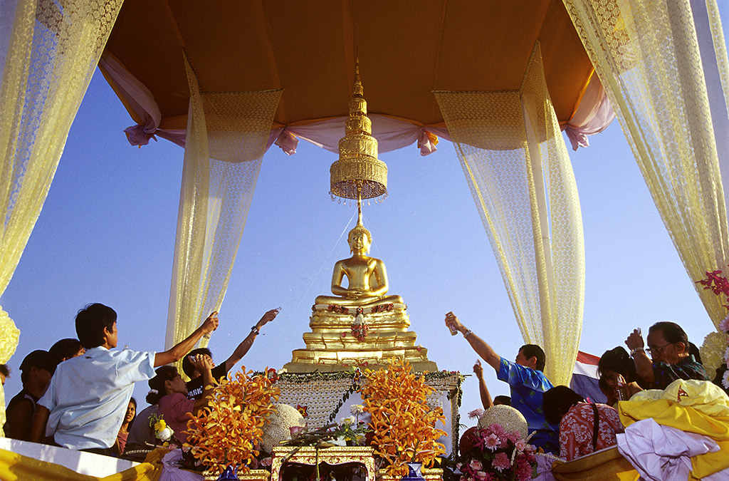 A população local joga água com jasmim ou rosas em imagens de Buda. Evite jogar sobre a cabeça da imagem! Foto cortesia Tourism Athority Thailand